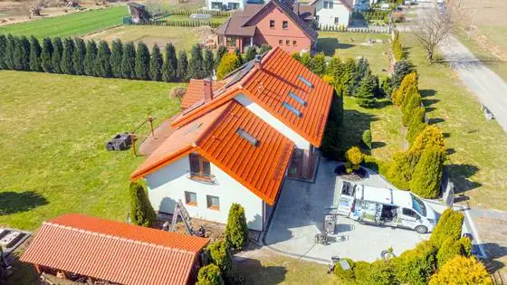 Dom od tyłu z umytą wiatą, dachem i kostką, ekipa i sprzęt CleanTech na podjeździe – Bierkowo k. Słupska, CleanTECH
